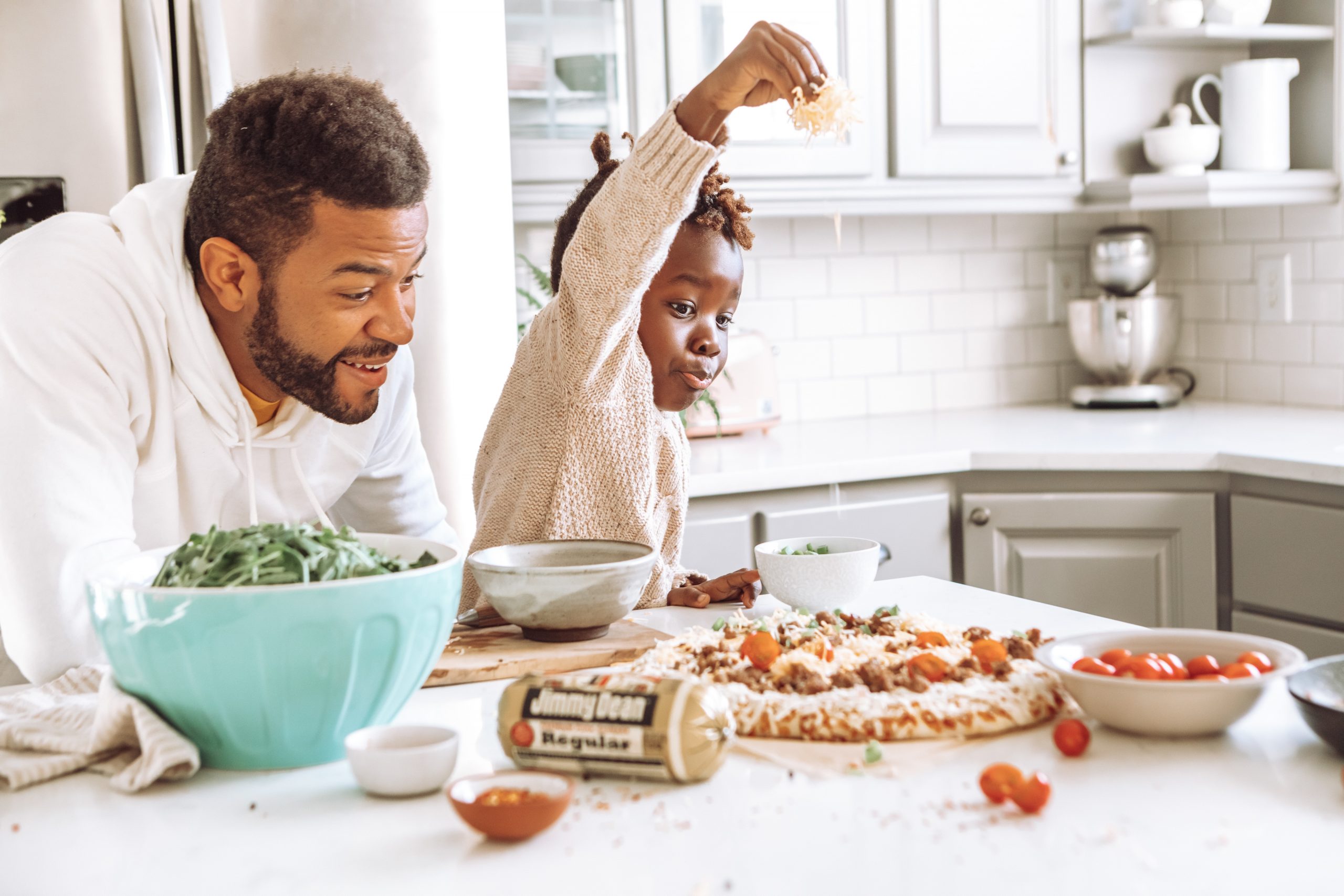 Father and daughter at kitchen counter top making pizza. Easy Tools to Plan Your Meals. How to create a simple meal plan